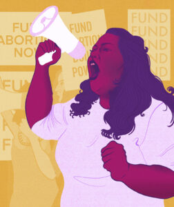 Person shouts into a megaphone at a rally supporting abortion funds, with signs urging fund abortion now and build power.
